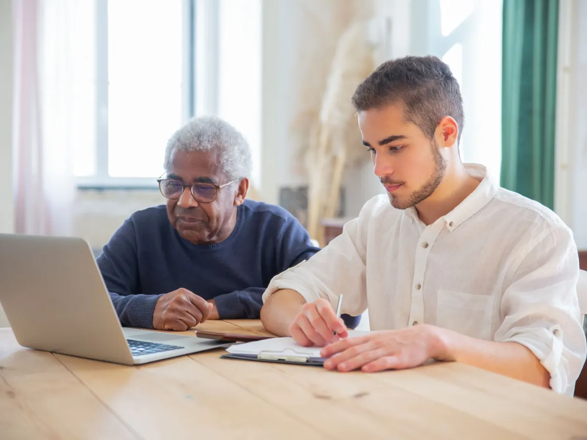 Two generations reviewing information together. Illustrative stock photography, not customers.
