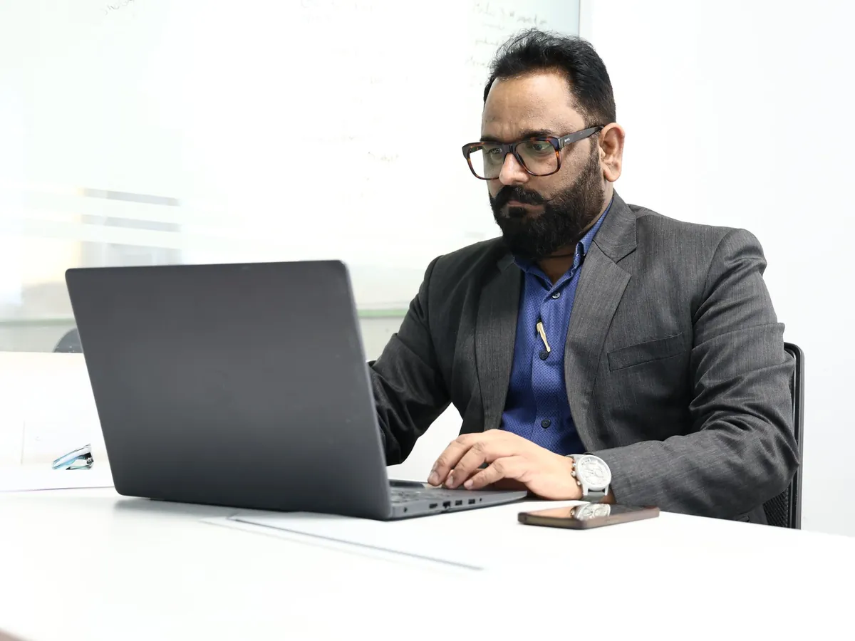 A founder working at a laptop. Illustrative stock photography, not customers.